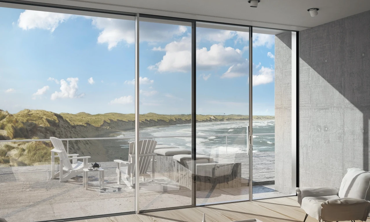 Slim-frame sliding doors overlooking a coastal landscape